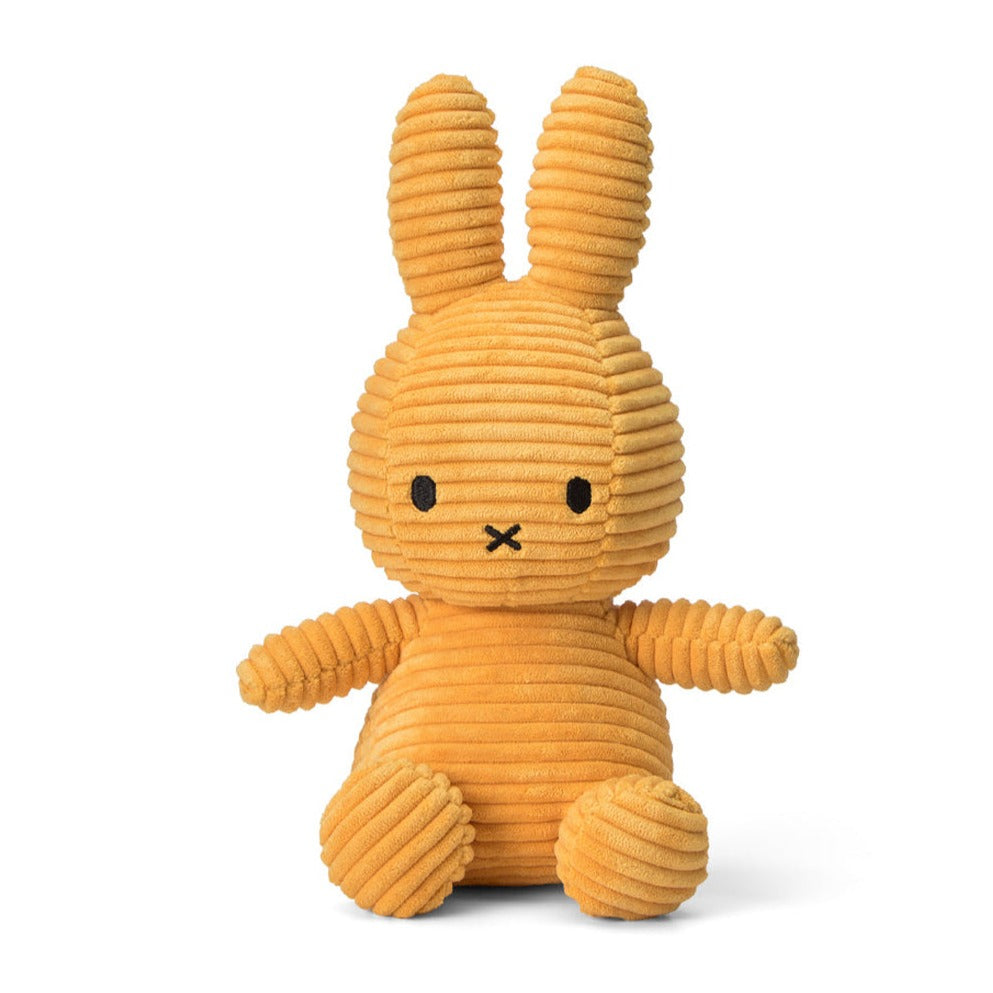An orange, corduroy Miffy rabbit plush toy sitting upright.