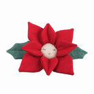 Red and green fabric poinsettia toy with embroidered face.