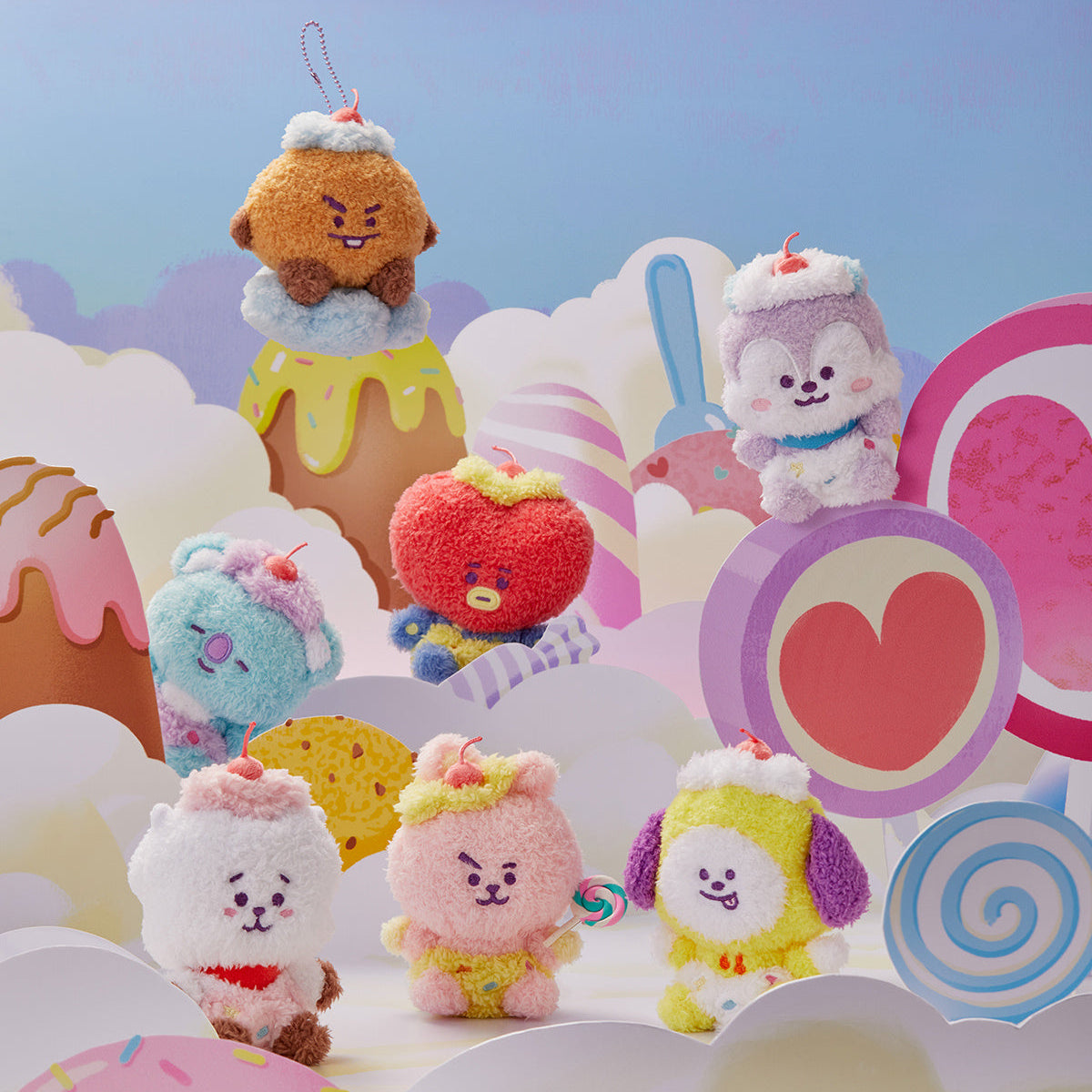 A group of plush BT21 characters dressed as desserts, set against a candy-themed backdrop.