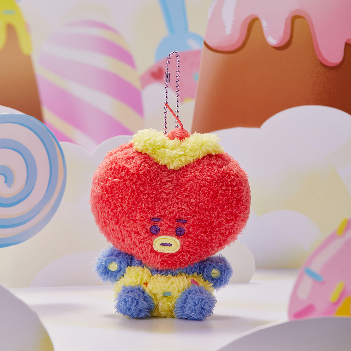 Red, yellow, and blue plush character keychain.