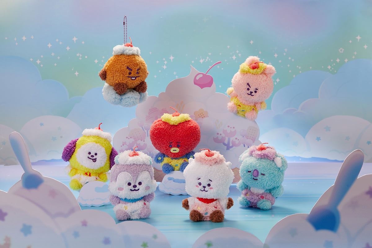 Seven plush BT21 characters dressed as dessert. Pastel-colored cartoon backdrop.