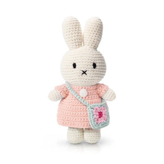 Crocheted Miffy bunny wearing pink dress and turquoise bag.