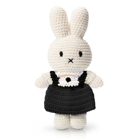 Crocheted Miffy rabbit doll wearing a black dress.