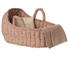 Pink floral quilted doll bassinet with pillow and knitted blanket.