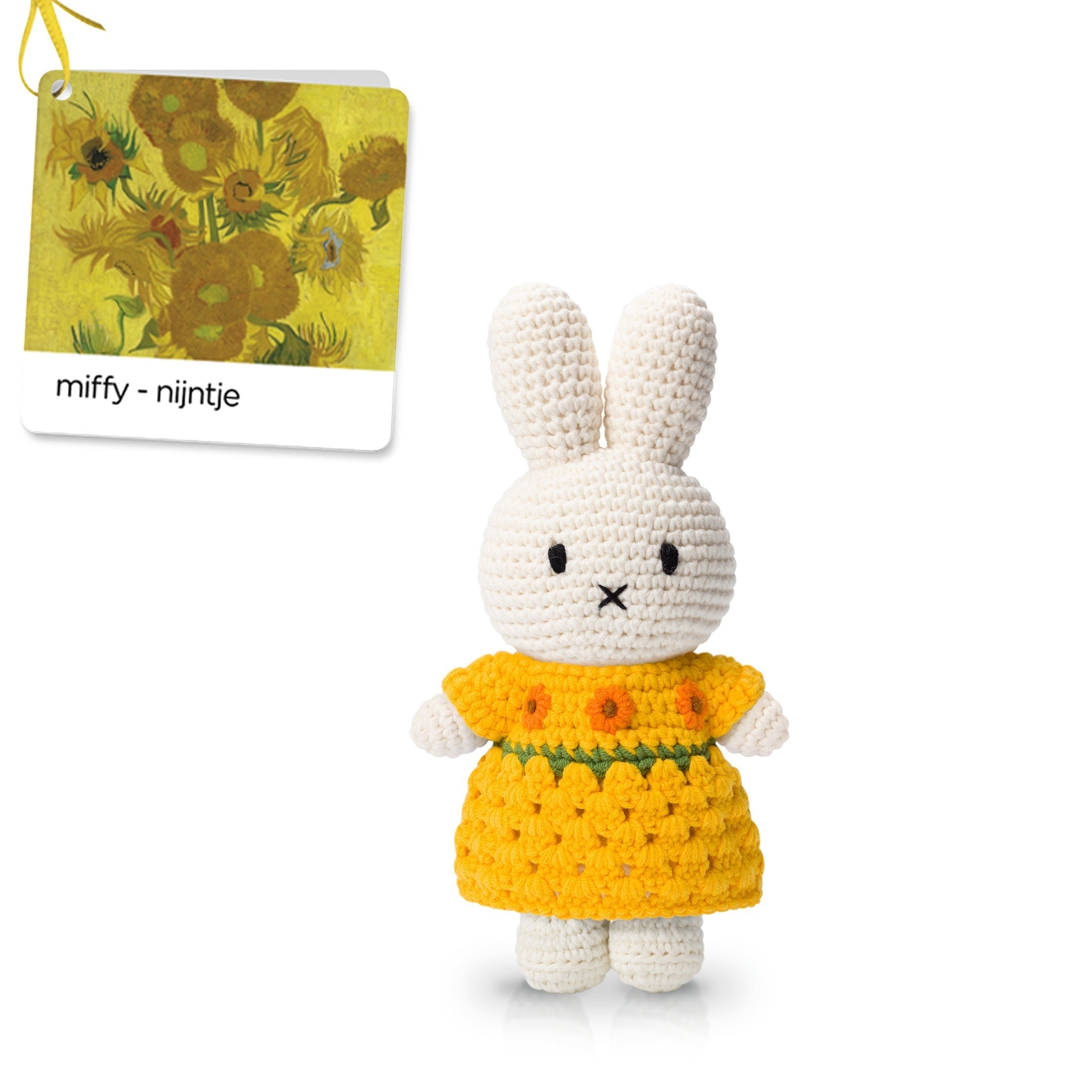 Crocheted Miffy doll wearing a yellow floral dress.
