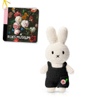 Crocheted Miffy doll in black overalls, with a museum tag.