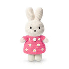 Crocheted bunny doll in a pink floral dress.