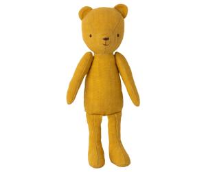 Here are some descriptive alt tags for the image, focusing on visual details:
* Yellow plush teddy bear standing.
* Stuffed bear toy, mustard yellow fabric.
* Handmade-style plush bear doll.
* Simple, stitched teddy bear toy.