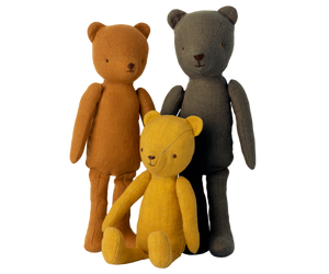 Here are a few concise and descriptive alt tags for the image, focusing on different visual aspects:
* **Three plush teddy bears in brown, gray, and yellow.**
* **Stuffed animal bears sitting and standing.**
* **Fabric teddy bears with minimal facial features.**
* **Teddy bear trio with mustard, grey, and brown fur.**