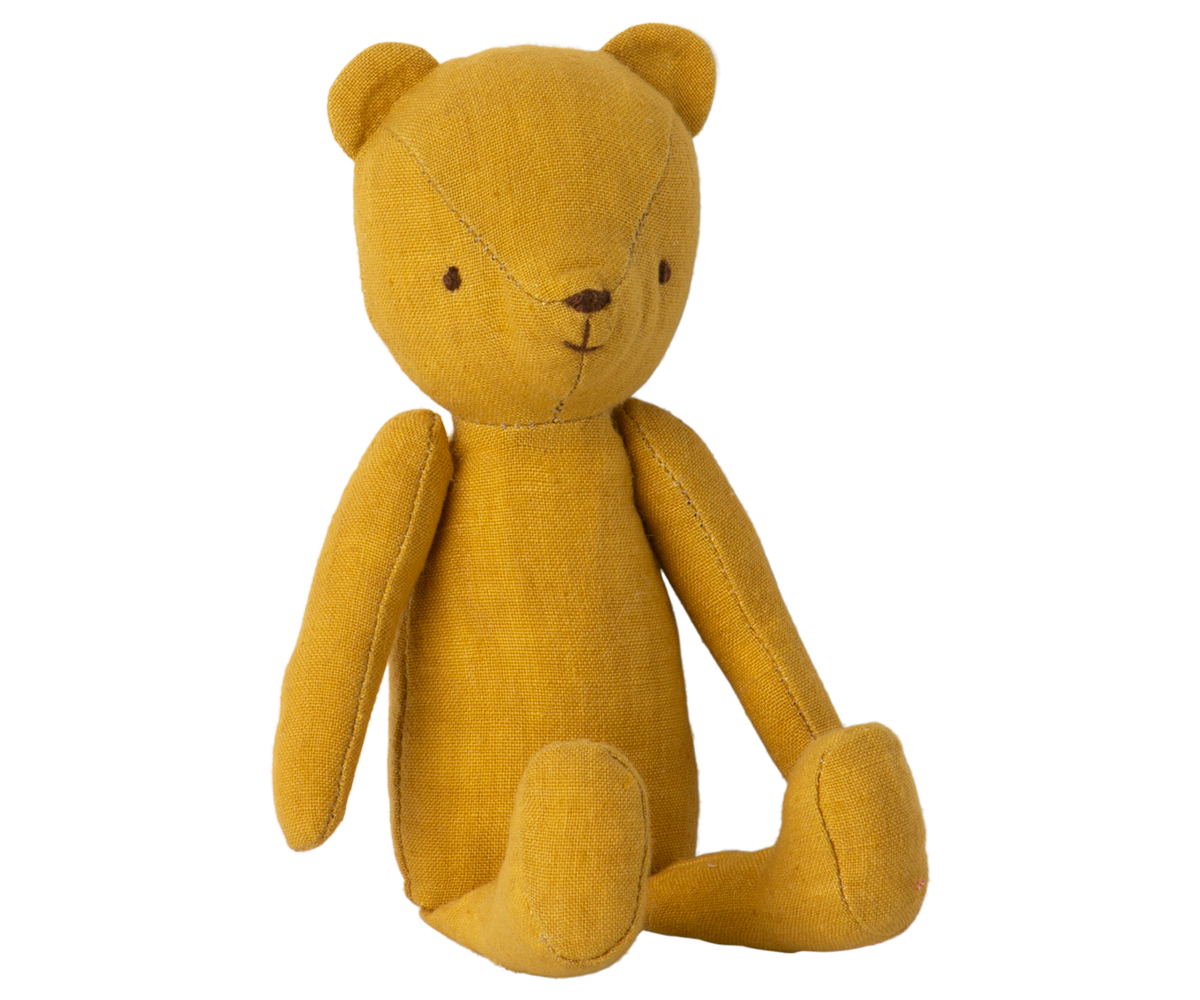Mustard yellow stuffed bear sitting upright.