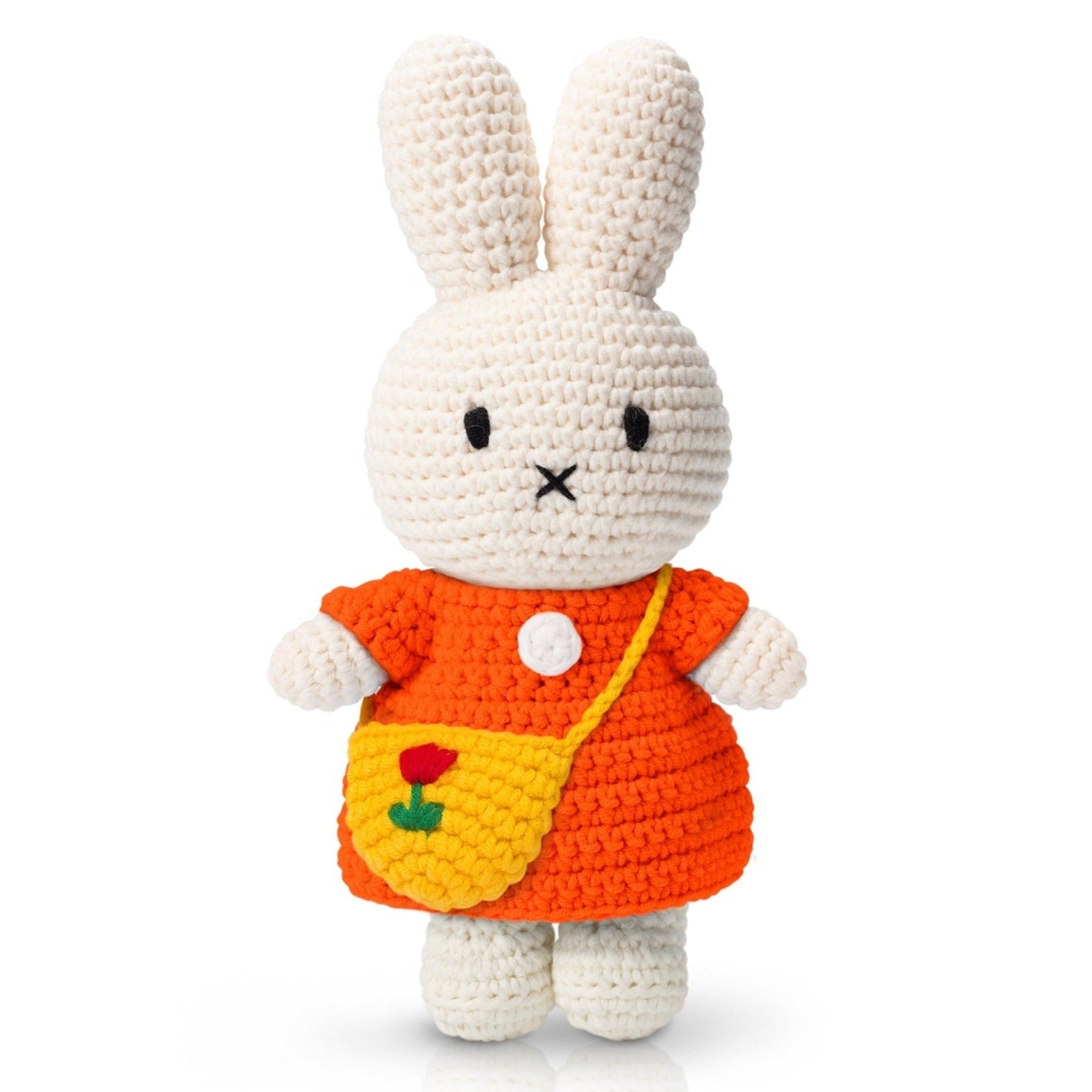 Crocheted Miffy doll wearing an orange dress and yellow bag.