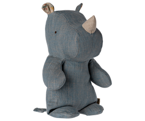 Stuffed denim blue rhinoceros toy with beige horn.