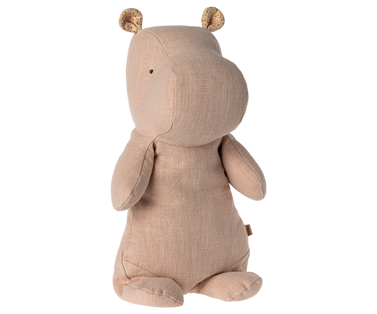 A beige plush hippopotamus with dotted ears.