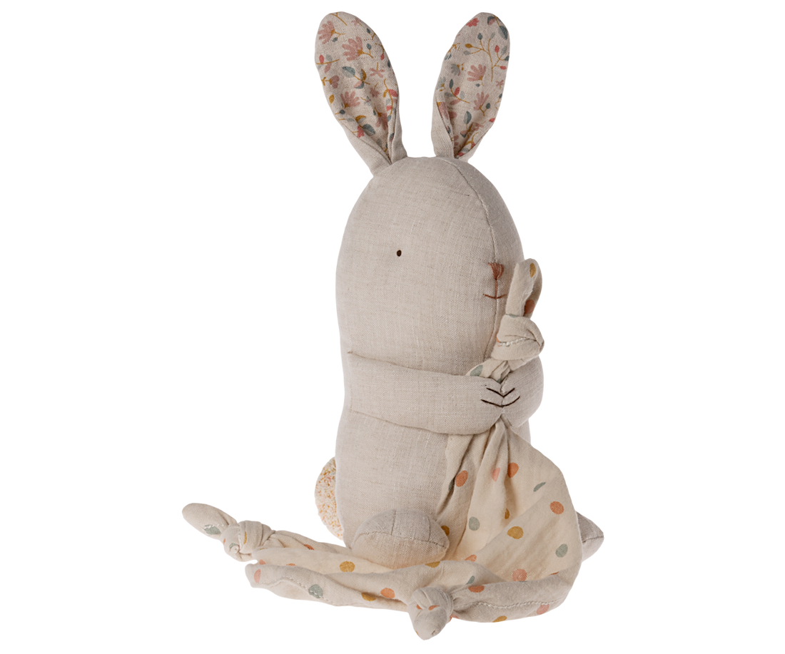 Stuffed bunny in linen fabric, floral ear linings, holding dotted blanket.
