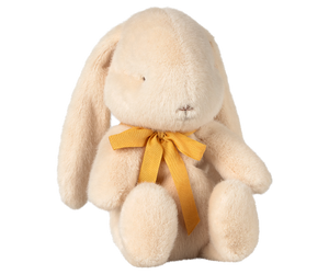 Stuffed tan bunny with yellow ribbon.