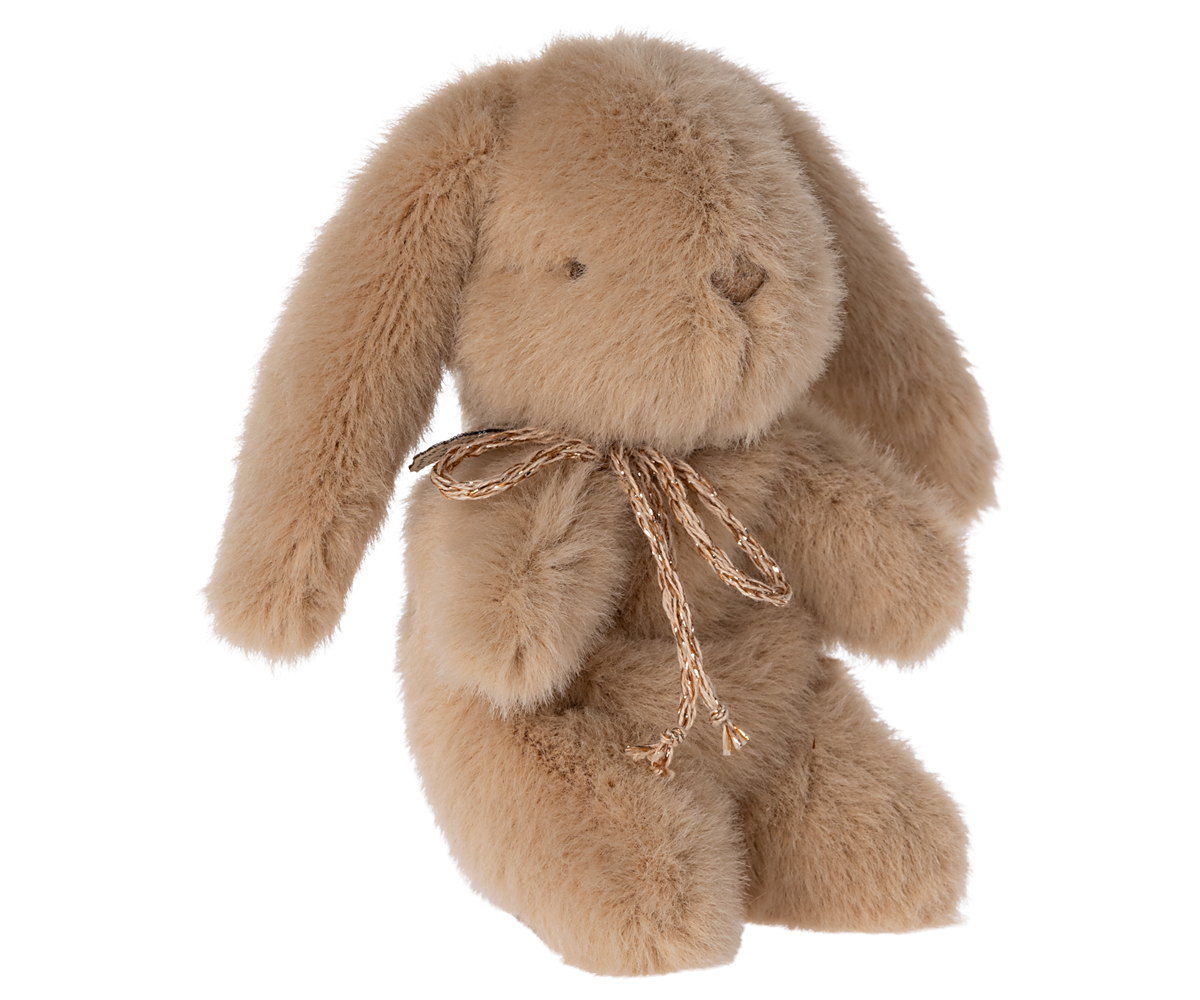 Tan plush rabbit toy with a decorative cord.