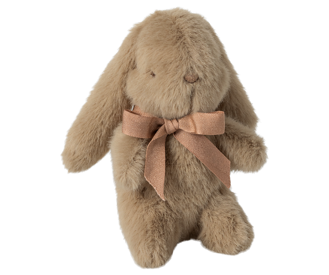 Tan plush bunny toy with a brown ribbon.