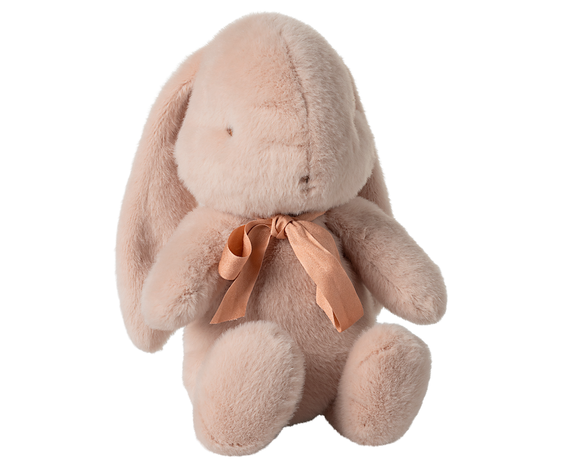 Pink plush bunny with a peach ribbon.