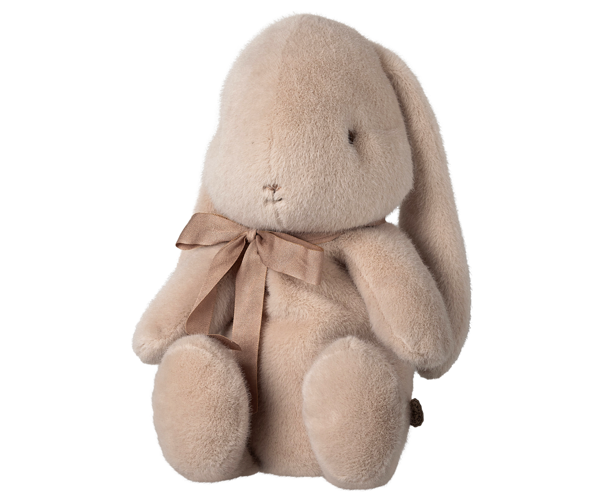 Stuffed bunny with brown ribbon bow.