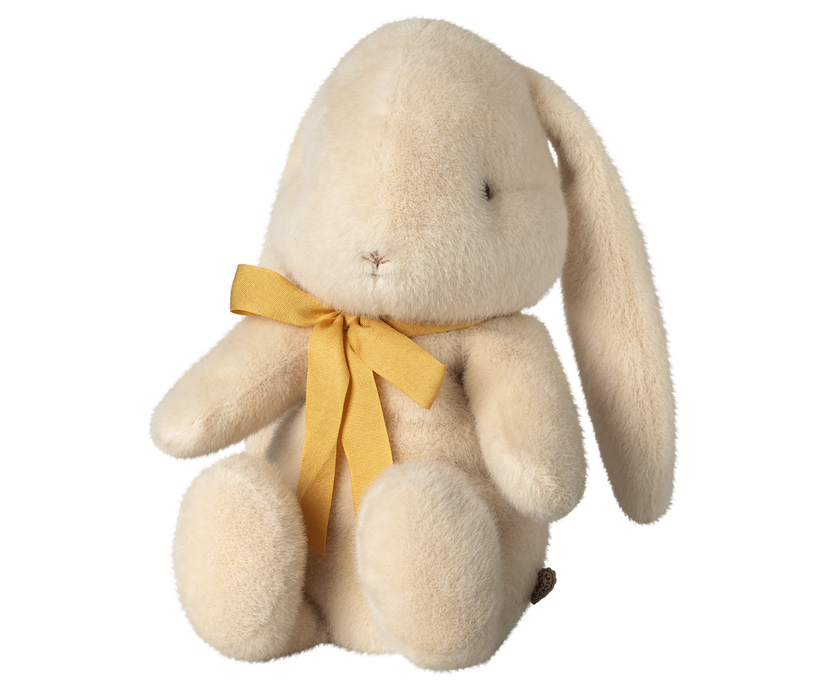 Stuffed bunny toy with a gold ribbon around its neck.
