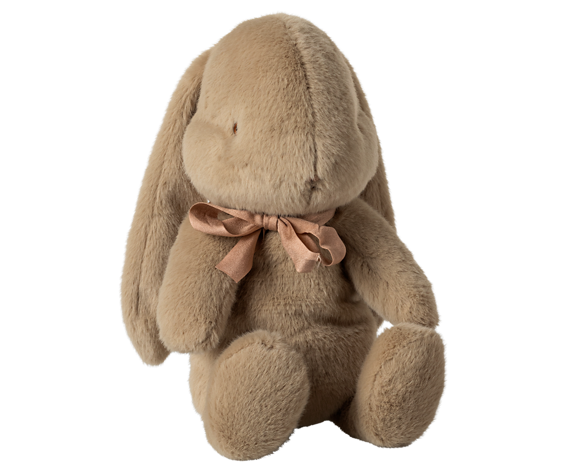 Stuffed brown bunny with ribbon.