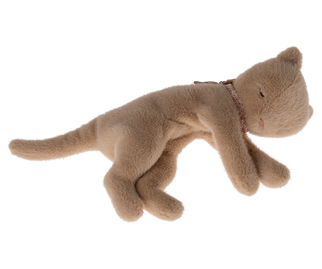 Stuffed, beige cat toy wearing a floral collar.