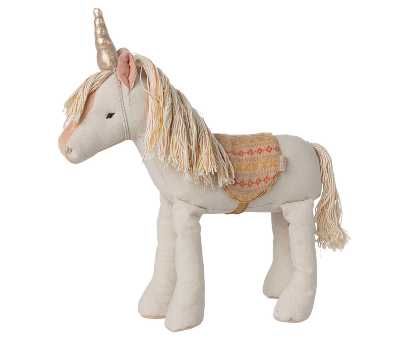Stuffed unicorn toy with gold horn and patterned saddle.