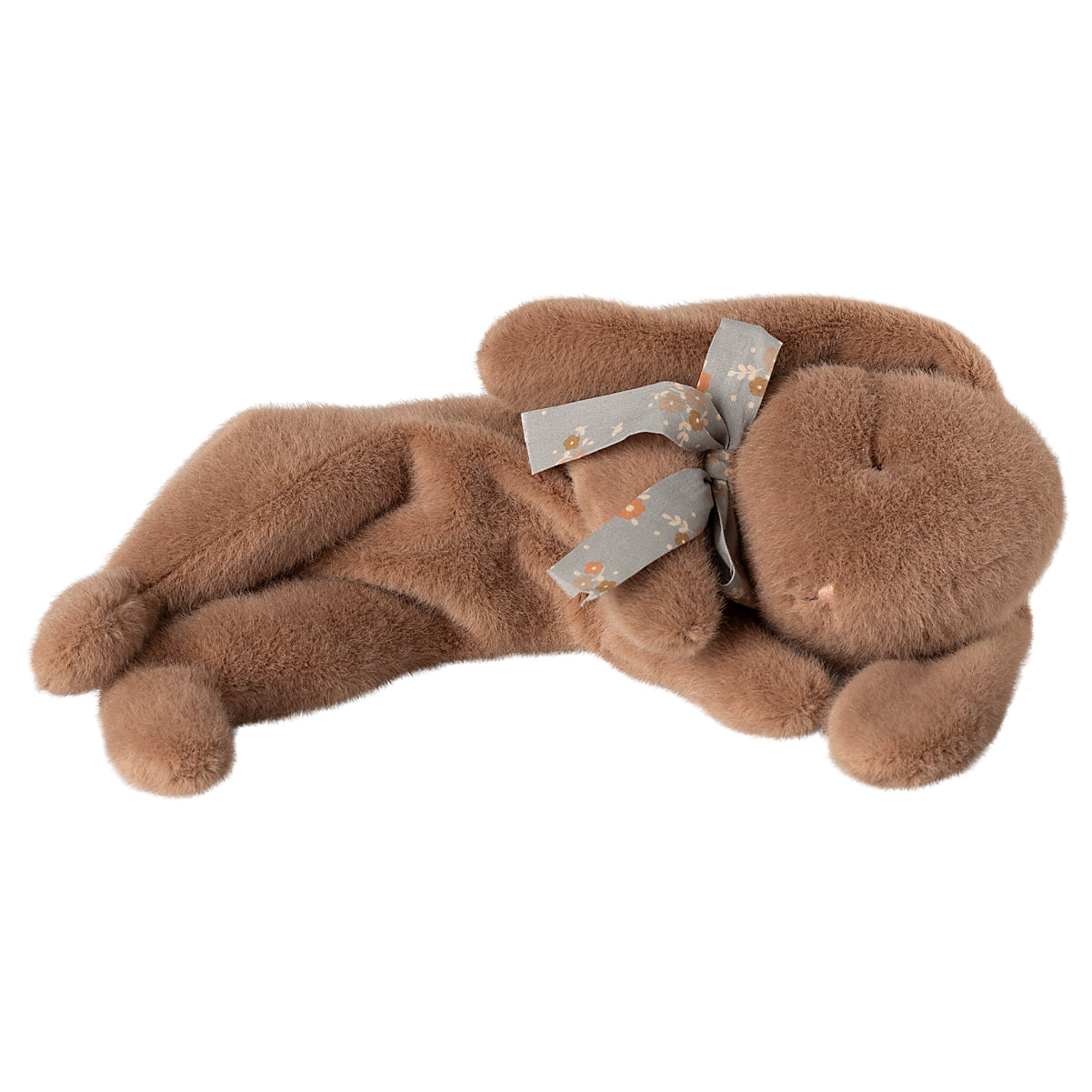 Brown plush bunny with floral bow, lying down.