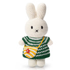 Crocheted bunny toy wearing a striped dress with a purse.