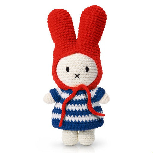 Handmade crochet bunny with a red hood and a blue and white striped dress.