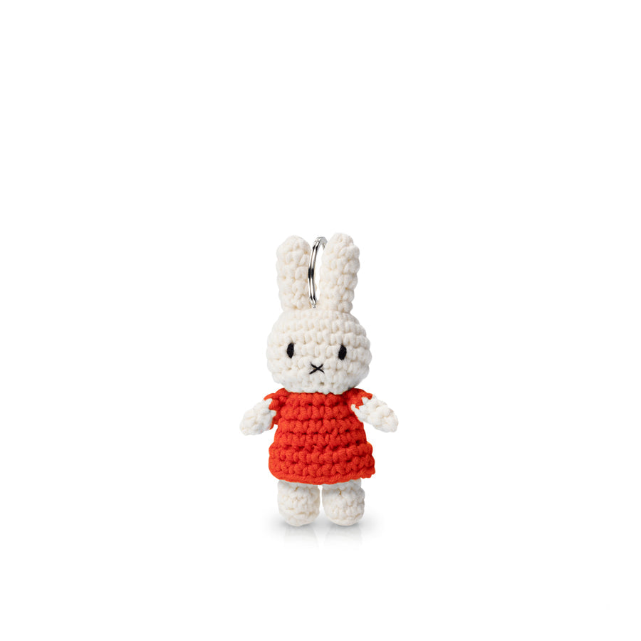 Crocheted Miffy keychain in a red dress.