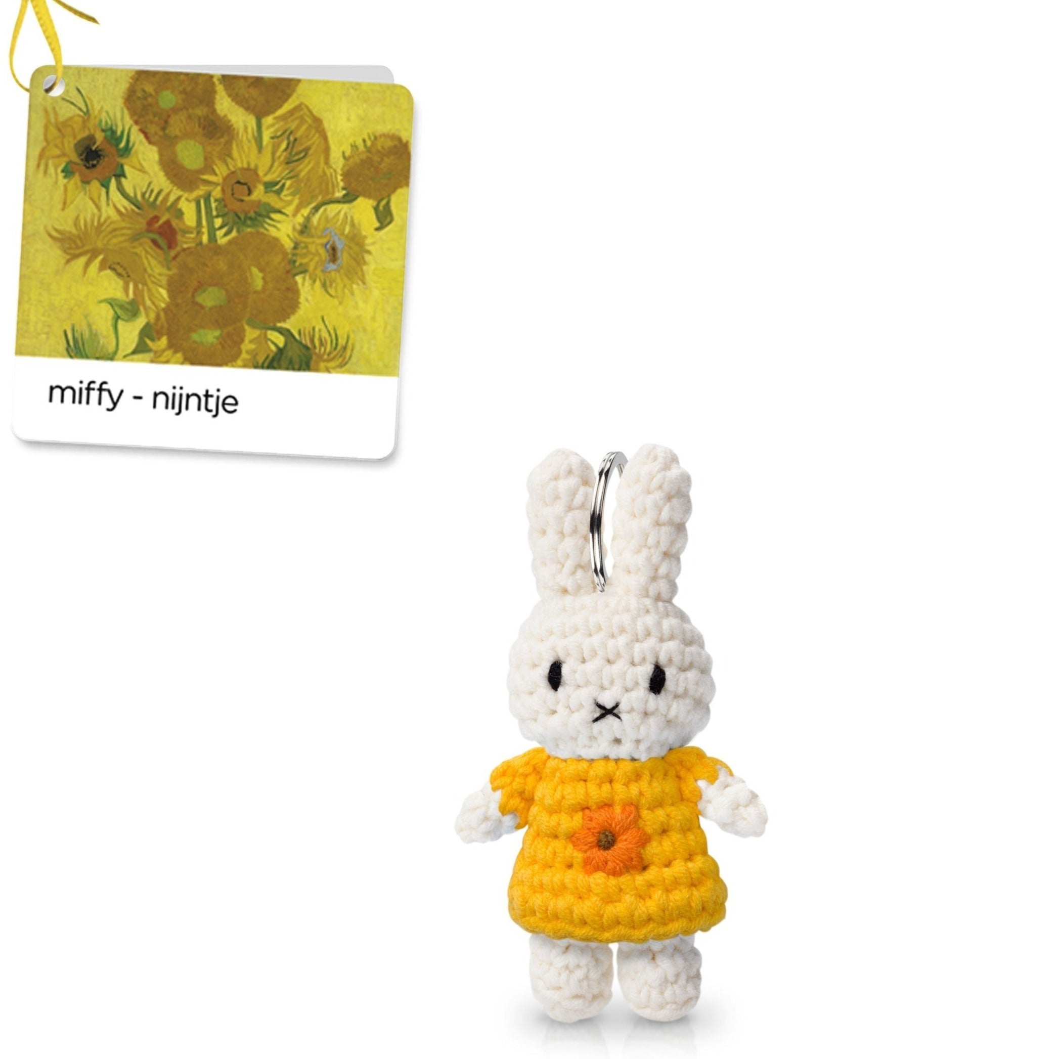 A crocheted Miffy rabbit in a yellow dress with a sunflower detail and a tag displaying Van Gogh's Sunflowers.