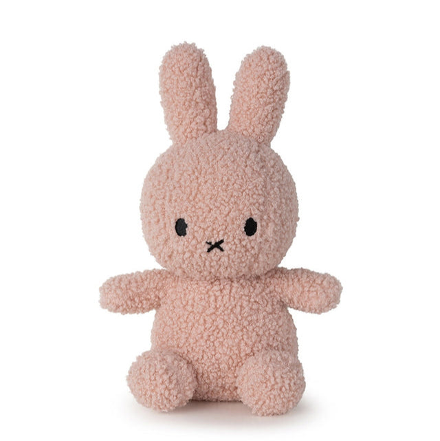 Pink, plush, stuffed Miffy rabbit toy sitting up.
