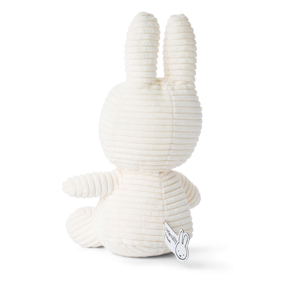 Back view of a corduroy white stuffed Miffy rabbit toy sitting.