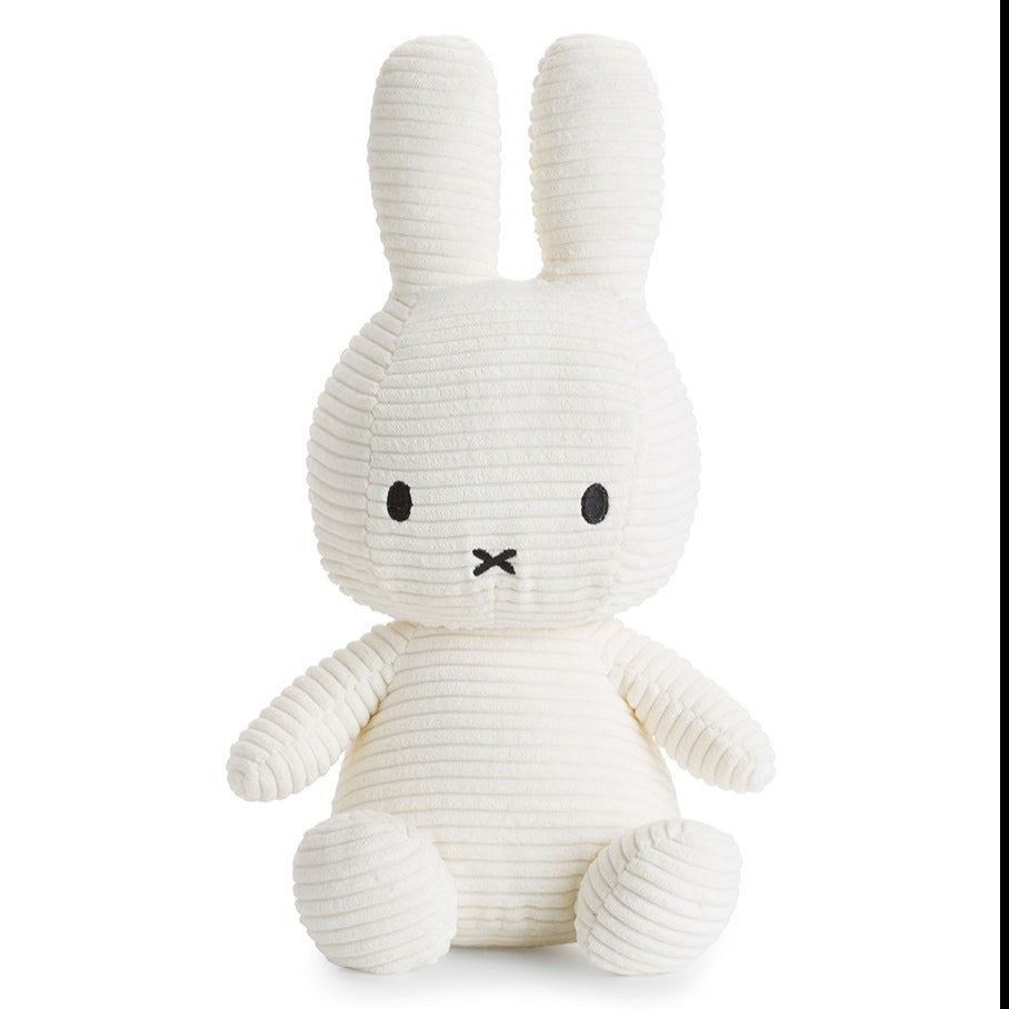 Off-white corduroy Miffy plush toy with black eyes and mouth.