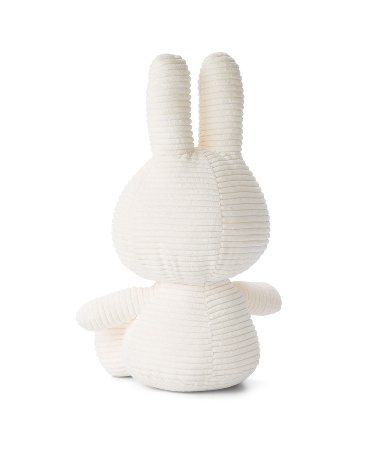 Rear view of a white corduroy stuffed rabbit.