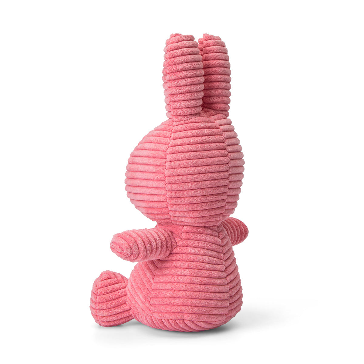 Pink corduroy stuffed rabbit, side view.