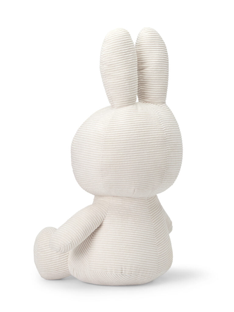 A corduroy stuffed bunny rabbit from behind.
