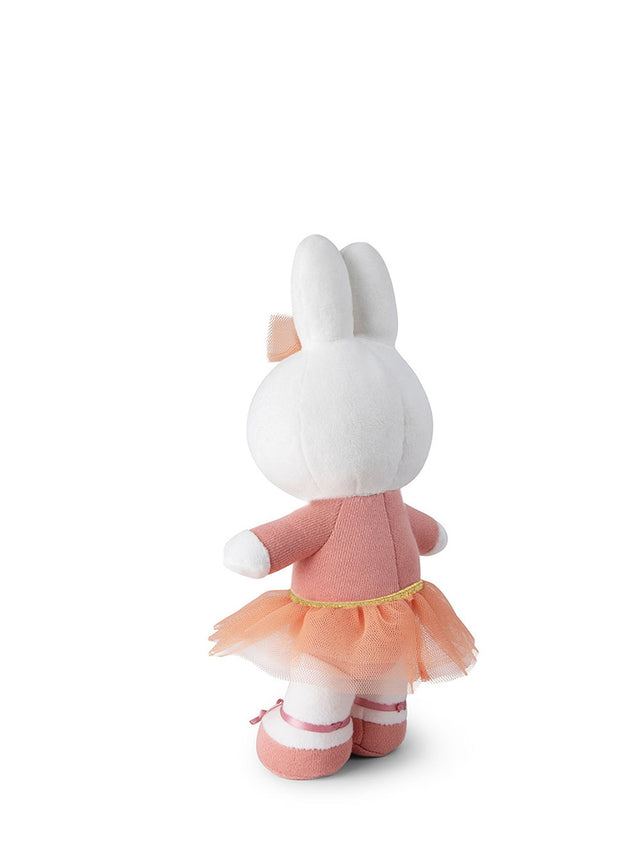 Plush toy rabbit in a pink dress on a white background