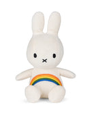 White corduroy plush bunny toy with rainbow on chest.