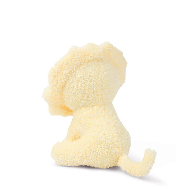 Rear view of a yellow, plush puppy toy sitting on a white background.
