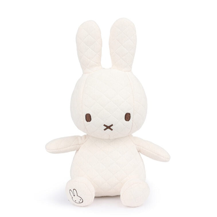 A stuffed cream-colored Miffy rabbit toy with brown eyes and a stitched "x" for a mouth.