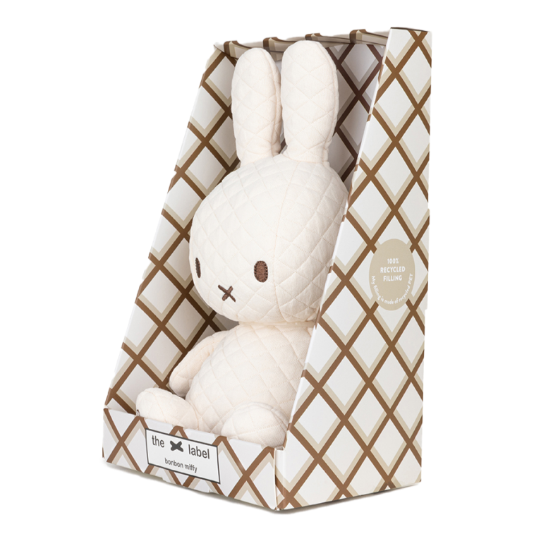 Miffy plush toy in patterned box.