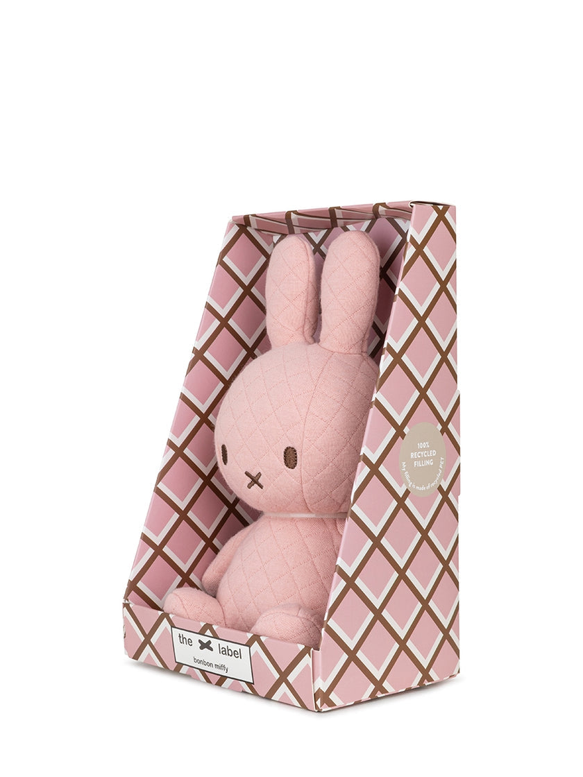 Pink Miffy stuffed toy in patterned box.