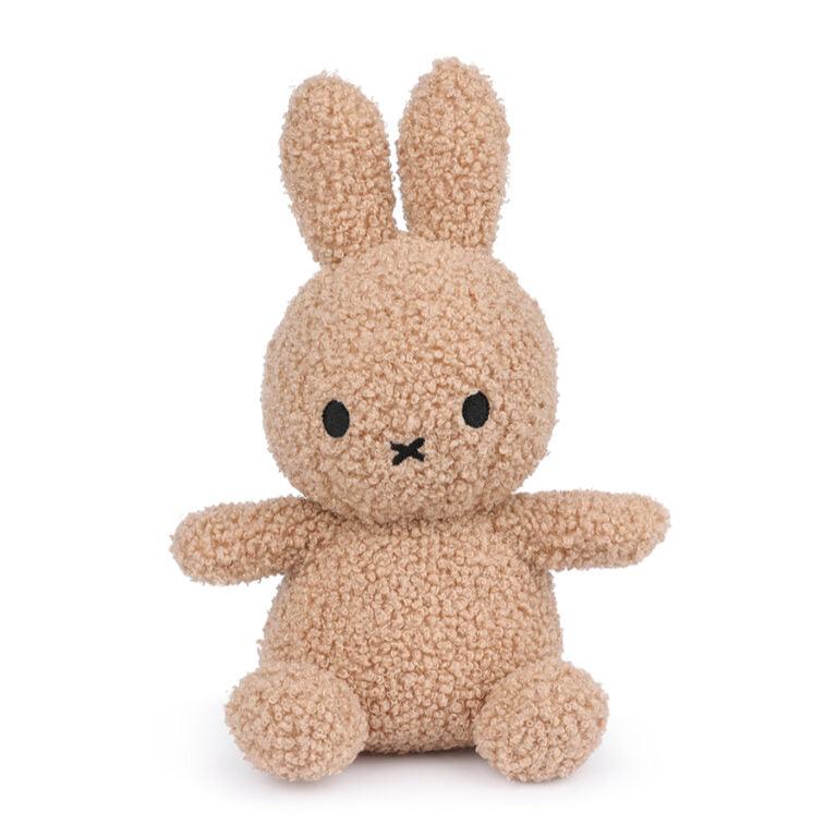 Stuffed Miffy bunny, beige curly texture.