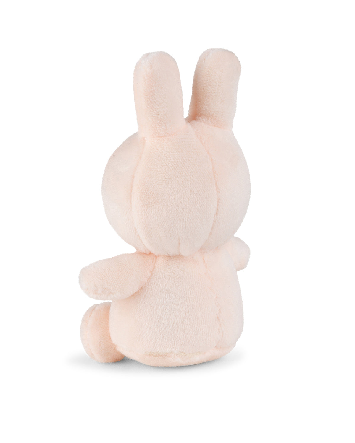 Back view of a peach-colored plush bunny.