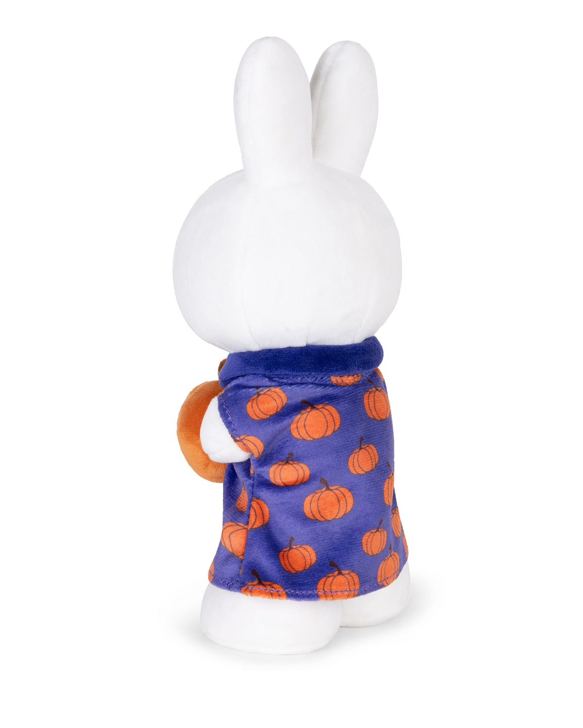 White stuffed Miffy rabbit in blue pumpkin-patterned pajamas.