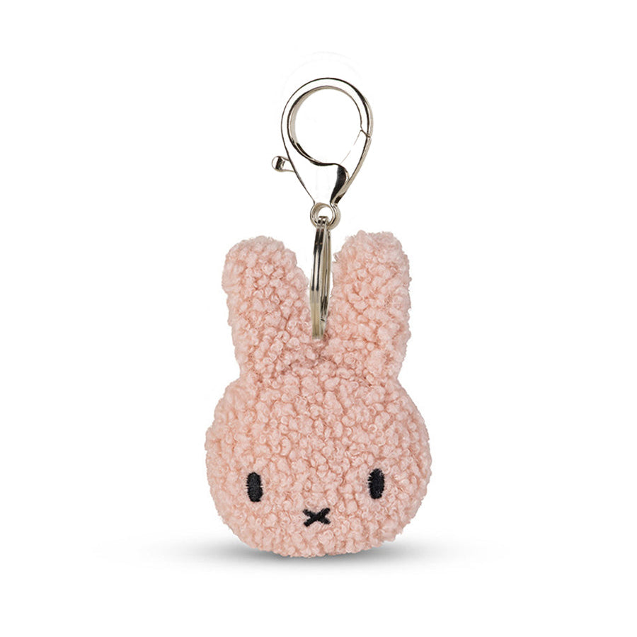 Pink bunny-shaped keychain on a white background