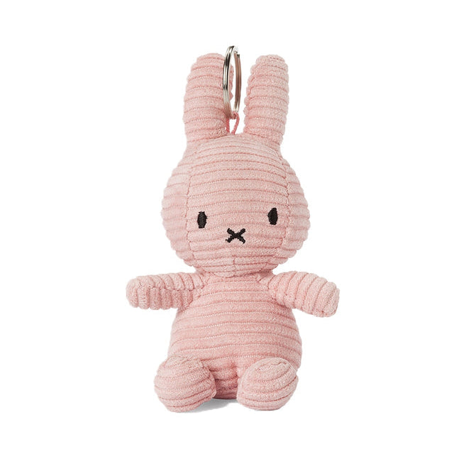 Pink bunny-shaped keychain on a white background