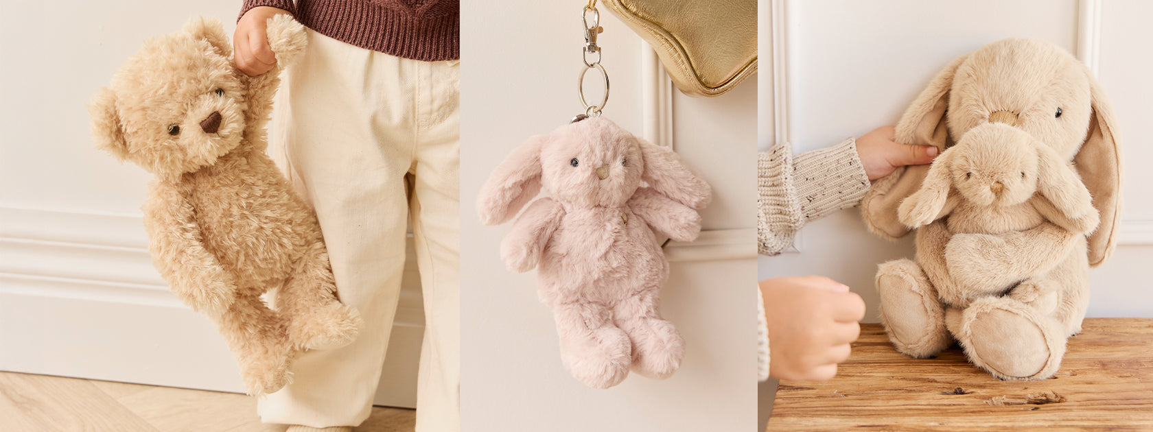 Stack of Snuggle Bunnies plushes on a wooden surface with a hand reaching towards them.